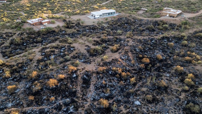 A drone view of a burnt field of Boulder View Fire, next to a residential area as fires prompt evacuations in Scottsdale, Maricopa County, Arizona, U.S., June 28, 2024.  REUTERS/Go Nakamura