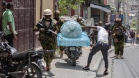 Polisi Kenya dengan senjata lengkap patroli keamanan menyusuri jalan-jalan Port-Au-Prince.
