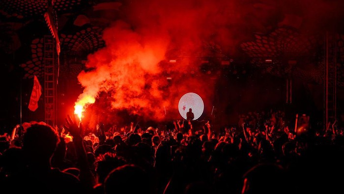 GLASTONBURY, ENGLAND - JUNE 30: Fatboy Slim is silhouetted against graphics as he performs on the Glade State in the early hours of day five of Glastonbury Festival 2024 at Worthy Farm, Pilton on June 30, 2024 in Glastonbury, England. Founded by Michael Eavis in 1970, Glastonbury Festival features around 3,000 performances across over 80 stages. Renowned for its vibrant atmosphere and iconic Pyramid Stage, the festival offers a diverse lineup of music and arts, embodying a spirit of community, creativity, and environmental consciousness. (Photo by Leon Neal/Getty Images)