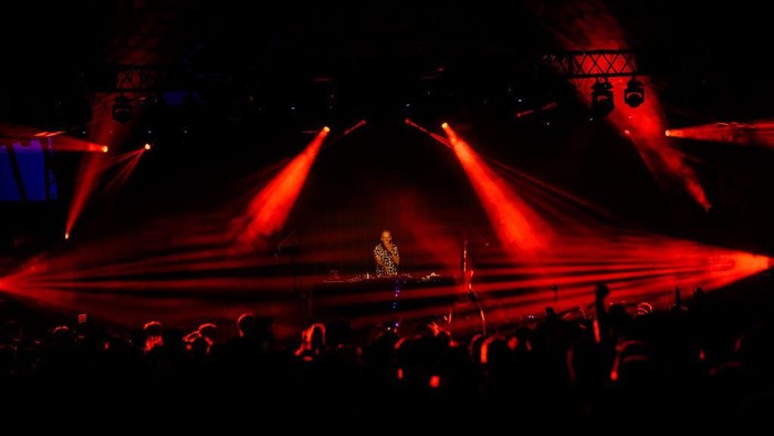 GLASTONBURY, ENGLAND - JUNE 30: Fatboy Slim is silhouetted against graphics as he performs on the Glade State in the early hours of day five of Glastonbury Festival 2024 at Worthy Farm, Pilton on June 30, 2024 in Glastonbury, England. Founded by Michael Eavis in 1970, Glastonbury Festival features around 3,000 performances across over 80 stages. Renowned for its vibrant atmosphere and iconic Pyramid Stage, the festival offers a diverse lineup of music and arts, embodying a spirit of community, creativity, and environmental consciousness. (Photo by Leon Neal/Getty Images)