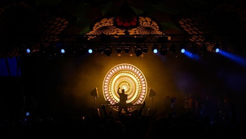 GLASTONBURY, ENGLAND - JUNE 30: Fatboy Slim is silhouetted against graphics as he performs on the Glade State in the early hours of day five of Glastonbury Festival 2024 at Worthy Farm, Pilton on June 30, 2024 in Glastonbury, England. Founded by Michael Eavis in 1970, Glastonbury Festival features around 3,000 performances across over 80 stages. Renowned for its vibrant atmosphere and iconic Pyramid Stage, the festival offers a diverse lineup of music and arts, embodying a spirit of community, creativity, and environmental consciousness. (Photo by Leon Neal/Getty Images)