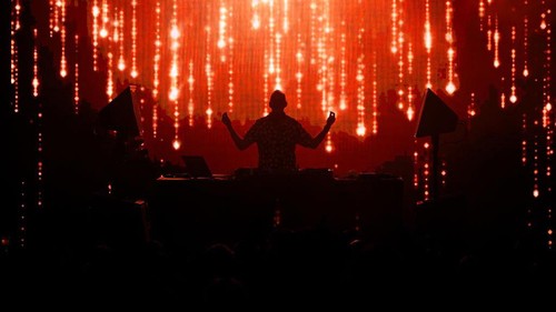 GLASTONBURY, ENGLAND - JUNE 30: Fatboy Slim is silhouetted against graphics as he performs on the Glade State in the early hours of day five of Glastonbury Festival 2024 at Worthy Farm, Pilton on June 30, 2024 in Glastonbury, England. Founded by Michael Eavis in 1970, Glastonbury Festival features around 3,000 performances across over 80 stages. Renowned for its vibrant atmosphere and iconic Pyramid Stage, the festival offers a diverse lineup of music and arts, embodying a spirit of community, creativity, and environmental consciousness. (Photo by Leon Neal/Getty Images)