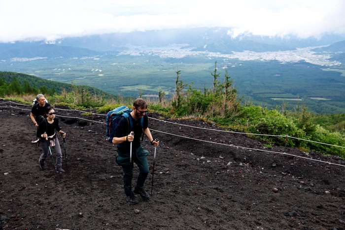 Visitors pose for a photo on the first day of climbing season at Fuji Yoshidaguchi Trail (Yoshida Route) at the fifth station of the slopes of Mount Fuji, in Fujiyoshida, Yamanashi Prefecture, Japan July 1, 2024. REUTERS/Issei Kato