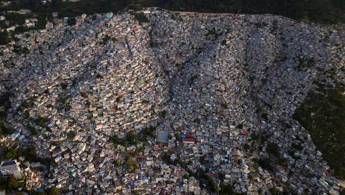 A drone view shows the sun setting over the Jalousie neighborhood, following the arrival of the first contingent of Kenyan police as part of a peacekeeping mission in the Caribbean country, in Port-au-Prince, Haiti June 30, 2024. REUTERS/Ricardo Arduengo