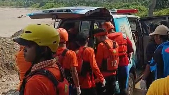 Petugas mengevakuasi jasad pelajar yang tenggelam di pantai Rio Beach