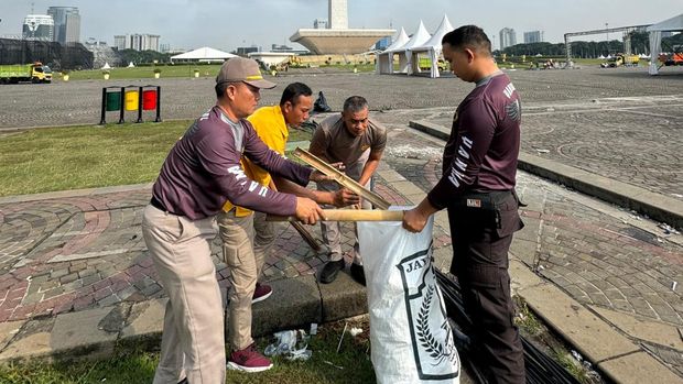 Polisi bersih-bersih Monas usai Peringatan Hari ke-78 Bhayangkara.