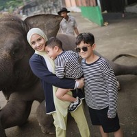 Ketika liburan ke Lembang, pemain film Dealova ini perlahan menggunakan hijab dengan lebih rapi. Hijab pashmina Gigi ia bentuk simpel dan rapi. Gigi berfoto sambil menggendong Rayyanza dan ada Rafathar di sampingnya. Foto: dok. Instagram @raffinagita1717.