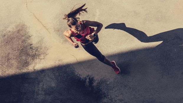 Women running in to the shadow