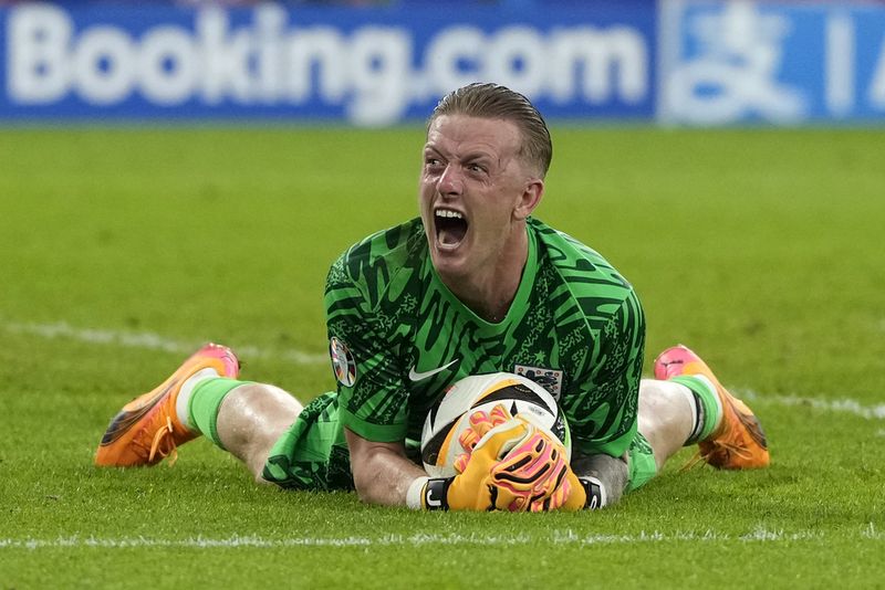 England's goalkeeper Jordan Pickford celebrates at the end of the round of sixteen match between England and Slovakia at the Euro 2024 soccer tournament in Gelsenkirchen, Germany, Sunday, June 30, 2024. (AP Photo/Antonio Calanni)