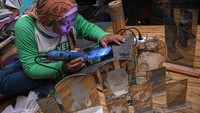 Perajin menyelesaikan pembuatan cinderamata dengan teknik seni grafir kaca di Yayasan Sumber Rizqy Center, Ciputat Timur, Tangerang Selatan, Rabu (3/7/2024).   