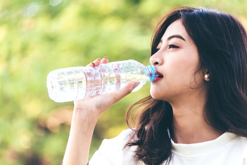 Illustration of Drinking a Plastic Bottle