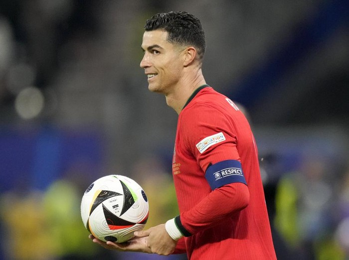 Portugals Cristiano Ronaldo holds the ball during a quarter final match between Portugal and France at the Euro 2024 soccer tournament in Hamburg, Germany, Friday, July 5, 2024. (AP Photo/Martin Meissner)