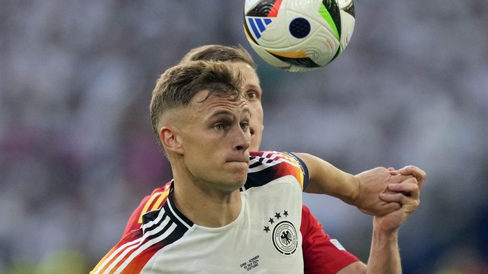 Germanys Joshua Kimmich, front, and Spains Dani Olmo battle for the ball during a quarterfinal match between Germany and Spain at the Euro 2024 soccer tournament in Stuttgart, Germany, Friday, July 5, 2024. (AP Photo/Antonio Calanni)