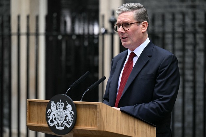 Britains incoming Prime Minister Keir Starmer and leader of the Labour Party, stands at the podium as he addresses the nation following his general election victory, outside 10 Downing Street in London on July 5, 2024, a day after Britain held a general election. Starmer became Britains new prime minister, as his centre-left opposition Labour party swept to a landslide general election victory, ending 14 years of right-wing Conservative rule. (Photo by Oli SCARFF / AFP)