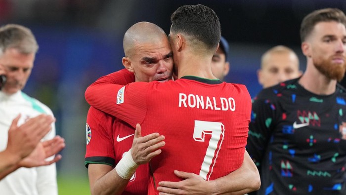 HAMBURG, GERMANY - JULY 5: Portugals forward Cristiano Ronaldo (R) comforts Portugals defender Pepe (L) following Theo Hernandezs penalty gives victory to France  in the UEFA Euro 2024 quarter-final football match between Portugal and France at the Volksparkstadion in Hamburg on July 5, 2024. (Photo by Emin Sansar/Anadolu via Getty Images)