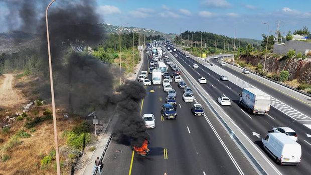 A drone view shows a fire that was lit by anti-government protesters on a day of protests marking 9 months since the deadly October 7 attack, under the slogan 