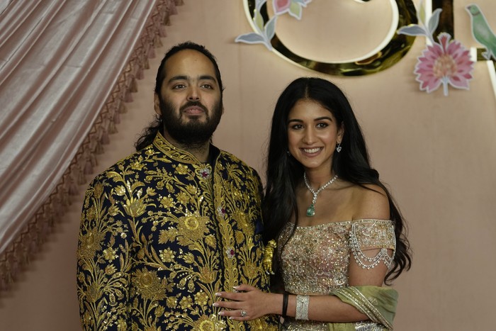 FILE - Anant Ambani, left, and Radhika Merchant pose for photographers during their pre-wedding ceremony in Mumbai, India, Friday, July 5, 2024. (AP Photo/Rajanish Kakade, File)