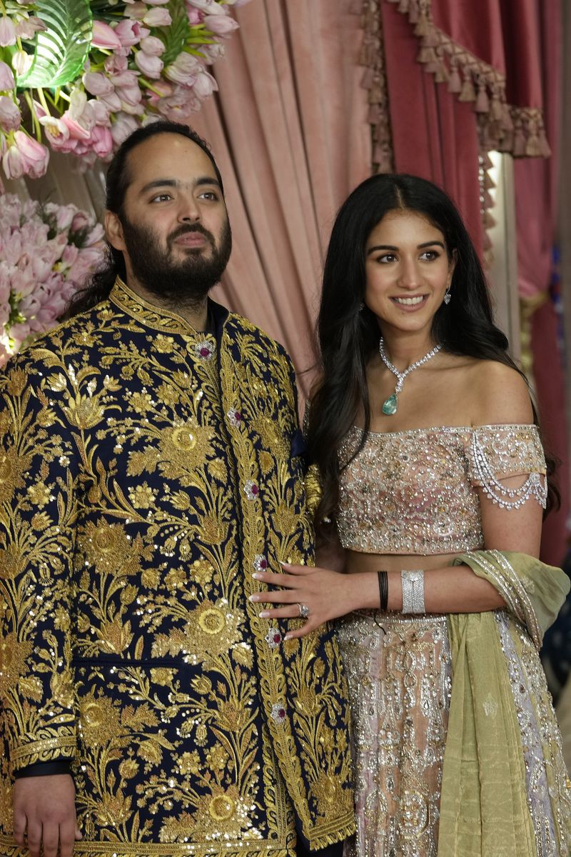 FILE - Anant Ambani, left, and Radhika Merchant pose for photographers during their pre-wedding ceremony in Mumbai, India, Friday, July 5, 2024. (AP Photo/Rajanish Kakade, File)