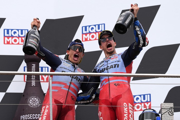 HOHENSTEIN-ERNSTTHAL, GERMANY - JULY 07: Marc Marquez of Spain and Gresini Racing MotoGP and Alex Marquez of Spain and Gresini Racing MotoGP celebrate on the podium after the MotoGP of Germany at the Sachsenring Circuit on July 07, 2024 in Hohenstein-Ernstthal, Germany. (Photo by Mark Wieland/Getty Images)