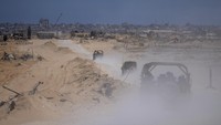 Kendaraan tentara Israel mengangkut sekelompok tentara dan jurnalis di Jalur Gaza selatan, Rabu (3/7/2024). Militer Israel mengundang wartawan untuk tur ke Rafah, tempat militer beroperasi sejak 6 Mei. Dua bulan lalu, sebelum pasukan Israel menyerbu Rafah, kota ini menjadi tempat perlindungan bagi sebagian besar penduduk Gaza yang berjumlah lebih dari 2 juta jiwa. Sekarang kota ini menjadi kota hantu yang tertutup debu.