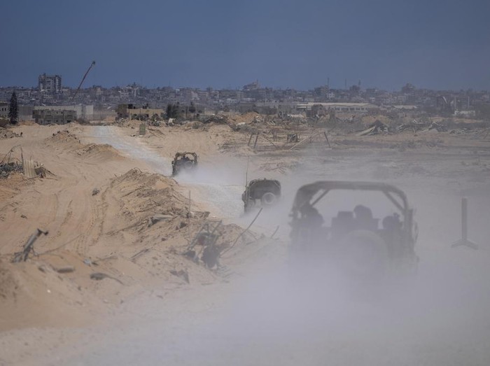 Israeli army vehicles transport a group of soldiers and journalists inside the southern Gaza Strip, Wednesday, July 3, 2024. The Israeli military invited reporters for a tour of Rafah, where the military has been operating since May 6. (AP Photo/Ohad Zwigenberg, Pool)