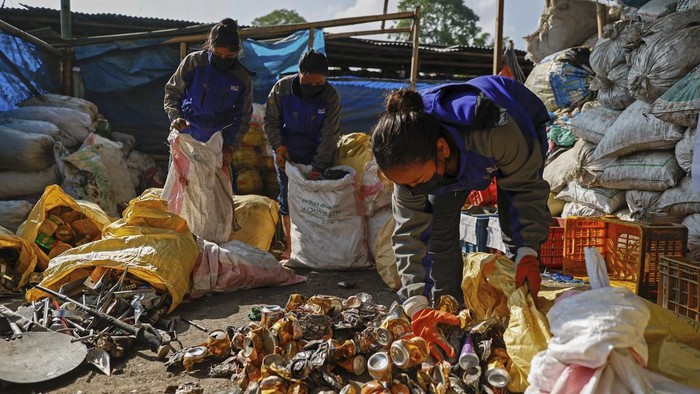 Workers segregate the garbage collected en route Mount Everest, at a facility operated by Agni Ventures, an agency that manages recyclable waste, in Kathmandu, Nepal, Monday, June 24, 2024. The Nepal government-funded team of soldiers and Sherpas removed 11 tons (24,000 pounds) of garbage, four dead bodies and a skeleton from Everest during this year's climbing season. (AP Photo/Sanjog Manandhar)