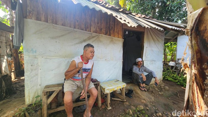 Habib Fahmi (Berkopiah) dan Aneng Anggara (mertua Ujang) di kediamannya di tengah kebun pisang