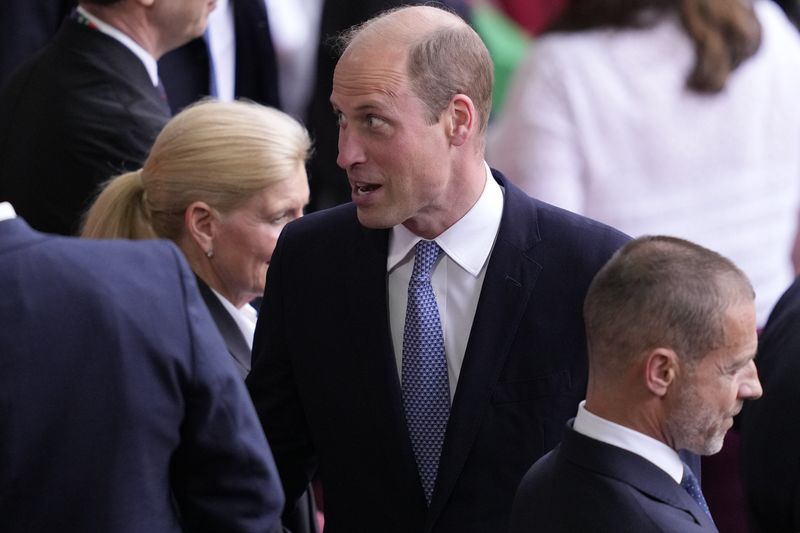 Britain's Prince William stands next to UEFA president Aleksander Ceferin before a quarterfinal match between England and Switzerland at the Euro 2024 soccer tournament in Duesseldorf, Germany, Saturday, July 6, 2024. (AP Photo/Andreea Alexandru)