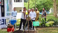 Jokowi juga menanam pohon di area sekolah tersebut. 