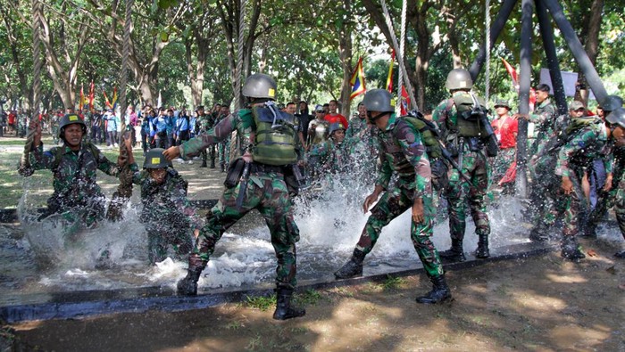 Prajurit Korps Marinir melewati rintangan kolam saat ajang ketangkasan halang rintang di Lapangan HR Kesatrian Marinir R Suhadi Gedangan, Sidoarjo, Jawa Timur, Jumat (12/7/2024). Kegiatan tersebut merupakan rangkaian lomba pembinaan satuan (Binsat) yang bertujuan untuk meningkatkan kemampuan fisik prajurit yang profesional dalam menghadapi tantangan. ANTARA FOTO/Umarul Faruq/aww.