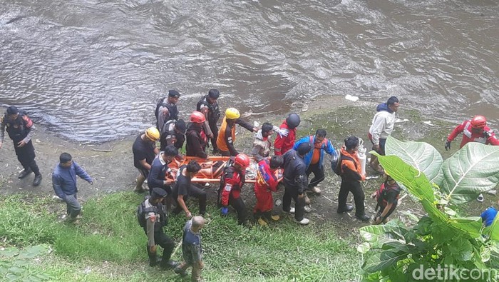 Petugas dan relawan mengevakuasi mahasiswa yang ditemukan di pinggir sungai bawah Jembatan Suhat Malang