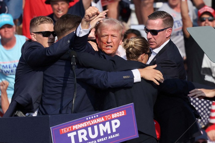 Security escort Republican presidential candidate and former U.S. President Donald Trump away from rally after gunfire rings out during a campaign rally at the Butler Farm Show in Butler, Pennsylvania, U.S., July 13, 2024, in this screen grab taken from a video. ABC/US Network Pool/ Handout via REUTERS ATTENTION EDITORS - THIS PICTURE WAS PROVIDED BY A THIRD PARTY. NO RESALES. NO ARCHIVES. MANDATORY CREDIT.