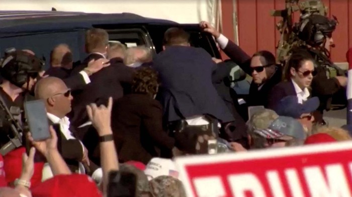 Security escort Republican presidential candidate and former U.S. President Donald Trump away from rally after gunfire rings out during a campaign rally at the Butler Farm Show in Butler, Pennsylvania, U.S., July 13, 2024, in this screen grab taken from a video. ABC/US Network Pool/ Handout via REUTERS ATTENTION EDITORS - THIS PICTURE WAS PROVIDED BY A THIRD PARTY. NO RESALES. NO ARCHIVES. MANDATORY CREDIT.