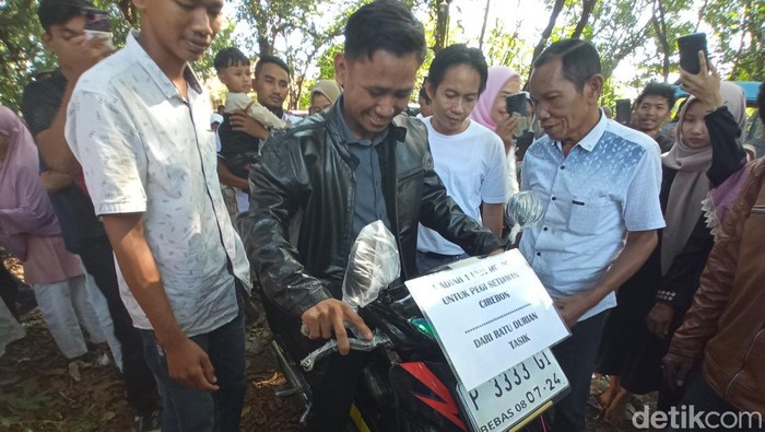 Pegi Setiawan menerima hadiah sepeda motor