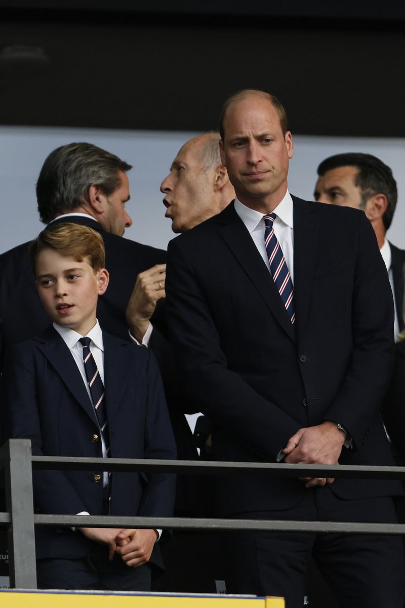 14 July 2024, Berlin: Soccer, UEFA Euro 2024, European Championship, Final, Spain - England, Olympiastadion Berlin, William (r), Prince of Wales, and his son Prince George stand in the stands before the start of the match. Photo: Federico Gambarini/dpa (Photo by Federico Gambarini/picture alliance via Getty Images)