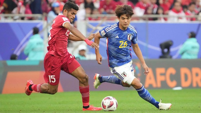 DOHA, QATAR - JANUARY 24: Kaishu Sano of Japan and Ricky Kambuaya of Indonesia compete for the ball during the AFC Asian Cup Group D match between Japan and Indonesia at Al Thumama Stadium on January 24, 2024 in Doha, Qatar. (Photo by Masashi Hara/Getty Images)