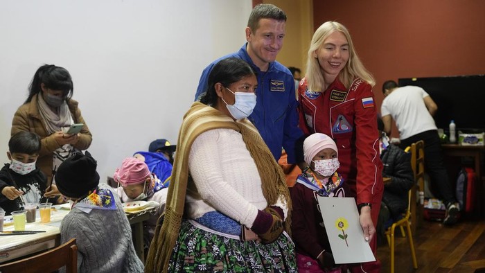 A young cancer patient creates art depicting their family to give to Russian astronaut Sergey Kud-Sverchkov who is visiting the Dr. Ovidio Aliaga Uria Children's Hospital in La Paz, Bolivia, Wednesday, July 17, 2024. (AP Photo/Juan Karita)