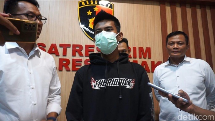 Pria berinisial AE (20, jaket hitam) pelaku pembunuhan mayat ABG bertato kupu-kupu di Demak ditangkap polisi, Jumat (19/7/2024).