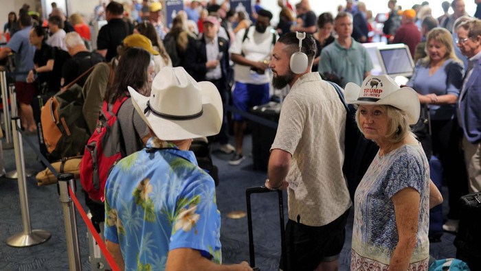 Passengers wait at Milwaukee Mitchell International Airport, after airlines grounded flights due to a worldwide tech outage caused by an update to CrowdStrikes 