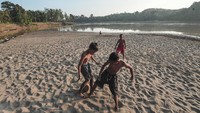 Sejumlah anak bermain sepak bola di tepi Sungai Batanghari yang surut di Desa Olak, Batanghari, Jambi, Sabtu (20/7/2024).