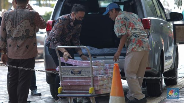 Petugas kejakasaan memindahkan uang barang bukti terkait kasus korupsi IUP PT Timah di Kejaksaan Negeri Jakarta Selatan, Senin (22/7/2024). (CNBC Indonesia/Faisal Rahman)