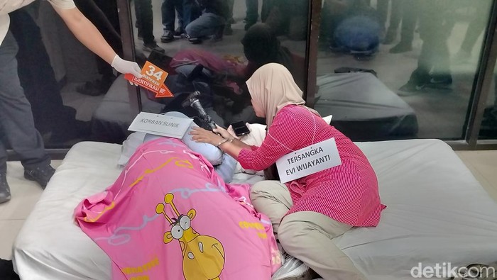 Evi memperagakan pembunuhan Sunik, ibu rumah tangga di Malang