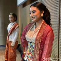 Ia memakai kebaya Timor dengan mengusung gaya layering yang kekininan. Padanan kebaya putih dan luaran berwarna merah diberi twist modern berupa korset batik motif floral berwarna cerah. (Foto: Daniel Ngantung/detikcom)