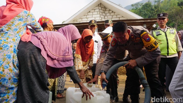 Anggota Polres Mojokerto menyalurkan air bersih di Desa Kunjorowesi