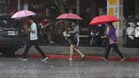 Orang-orang berjuang melawan hujan dan hembusan angin saat Topan Gaemi di Taipei, Taiwan, Rabu (24/7/2024).