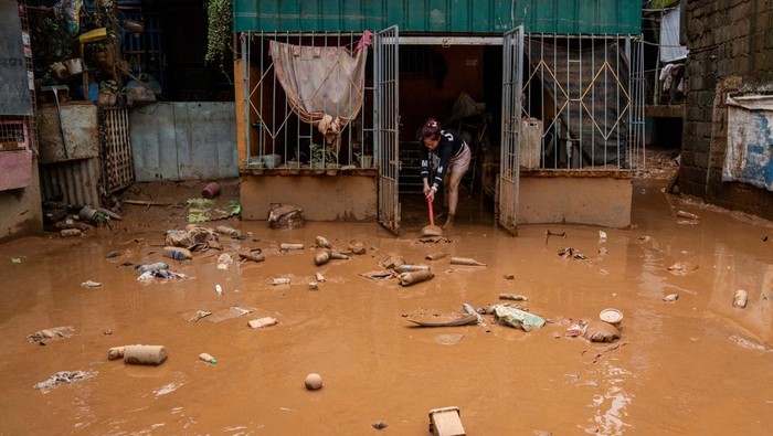 A man rests from cleaning mud from his house following the floods brought by Typhoon Gaemi, in San Mateo town, Rizal province, Philippines, July 25, 2024. REUTERS/Lisa Marie David