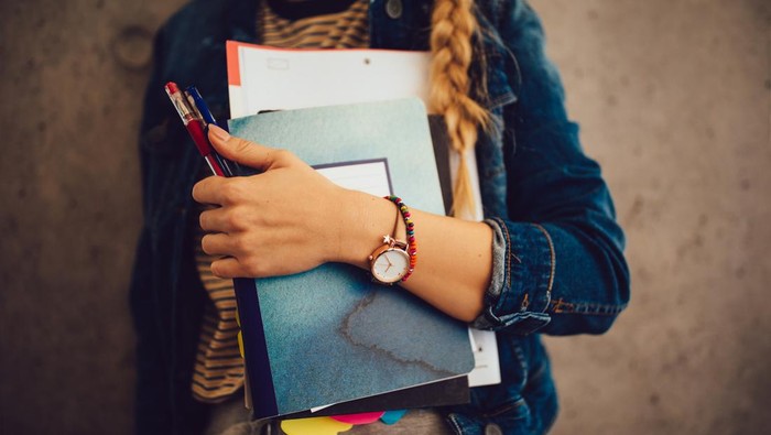 Student hold book after finish study  at university.