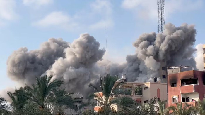 Smoke rises following an Israeli strike on a residential building, amid the ongoing conflict between Israel and Hamas, in Nuseirat in the central Gaza Strip, in this still picture taken from a video, July 24, 2024. Reuters TV via REUTERS Purchase Licensing Rights