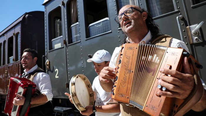 Musicians play music at the train station as part of the 