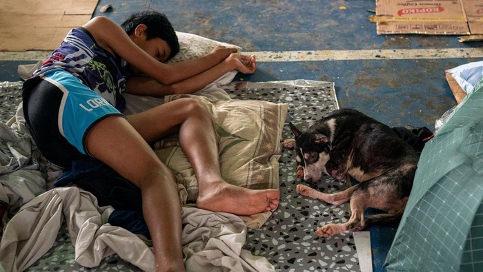 Warga Terdampak Banjir di Filipina Mengungsi di Lapangan Basket People take shelter at a basketball court temporarily converted into an evacuation center following the floods brought by Typhoon Gaemi, in San Mateo town, Rizal province, Philippines, July 25, 2024. REUTERS/Lisa Marie David